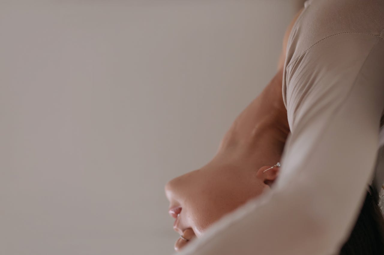 Close-up of a flexible woman performing a graceful yoga pose indoors.